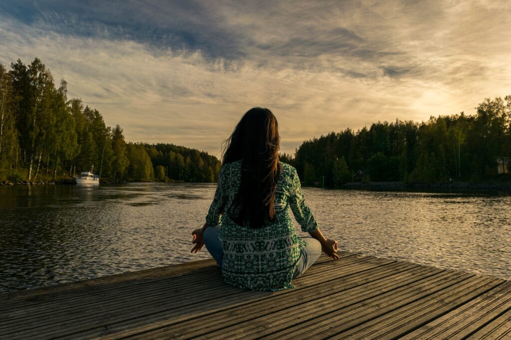 girl doing yoga at a lake